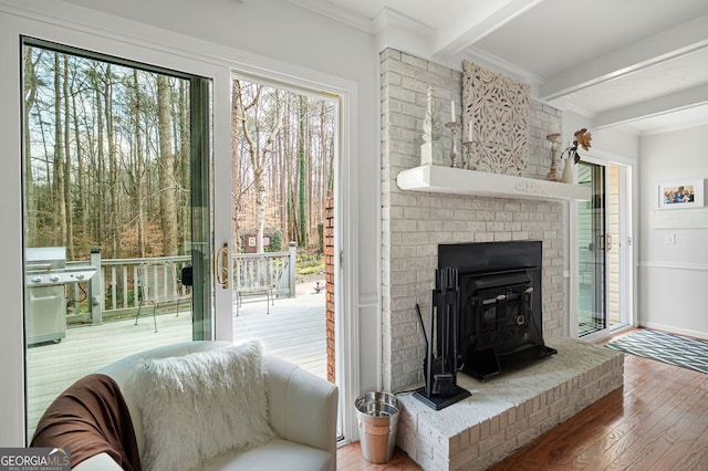 interior space with hardwood / wood-style floors, crown molding, and beamed ceiling