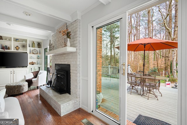 living room featuring beamed ceiling and hardwood / wood-style flooring