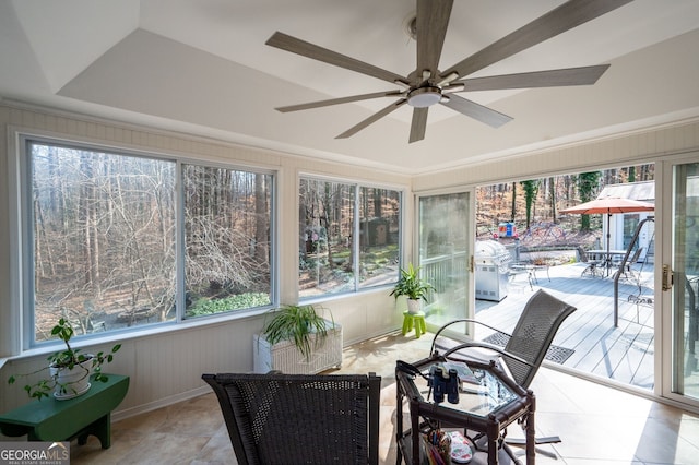 sunroom / solarium featuring ceiling fan and a healthy amount of sunlight