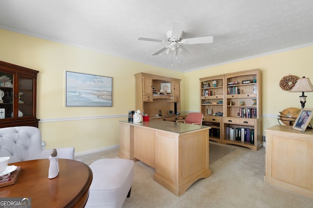 office area with crown molding, light carpet, ceiling fan, and a textured ceiling