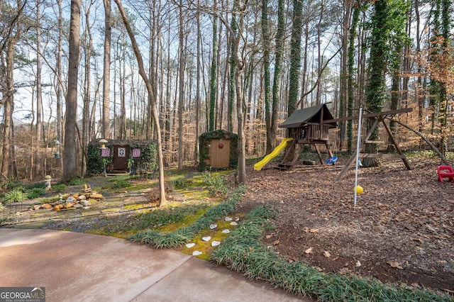 view of yard with a playground and a storage unit