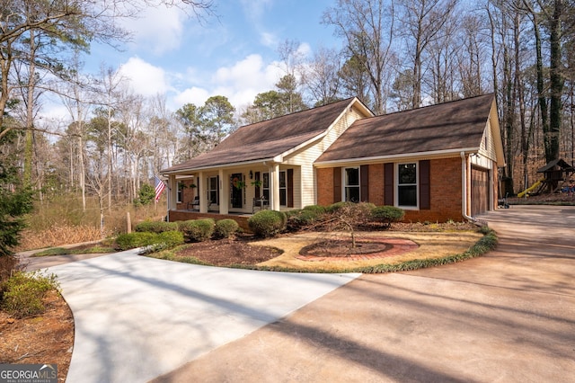 view of side of home with a garage and covered porch