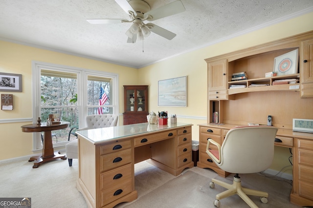 office space featuring crown molding, light colored carpet, a textured ceiling, and ceiling fan