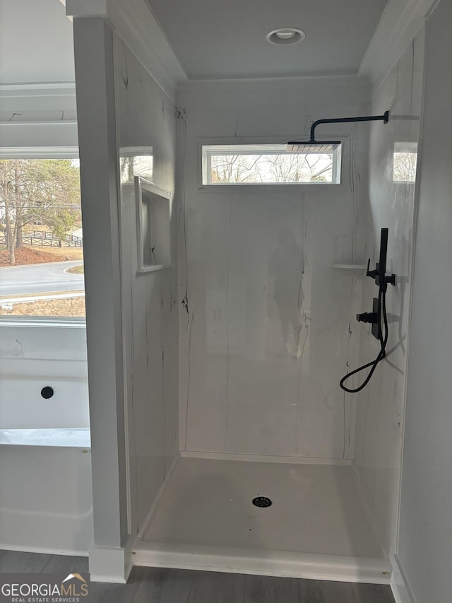 bathroom featuring plenty of natural light and tiled shower