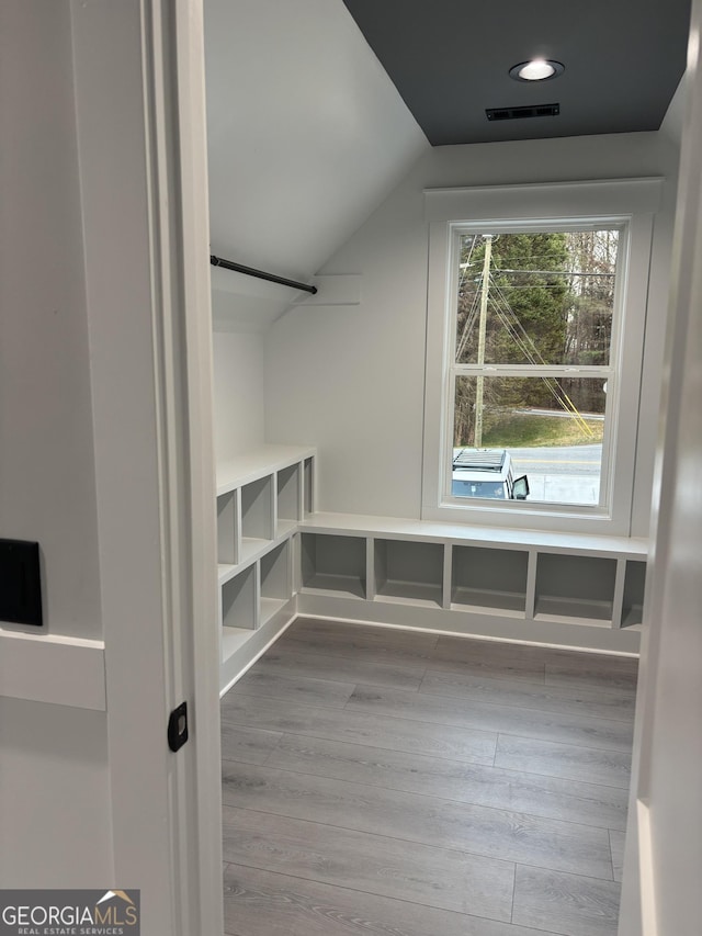 interior space with vaulted ceiling and light hardwood / wood-style floors