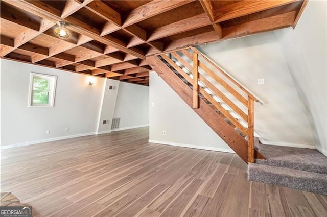 basement with dark hardwood / wood-style floors