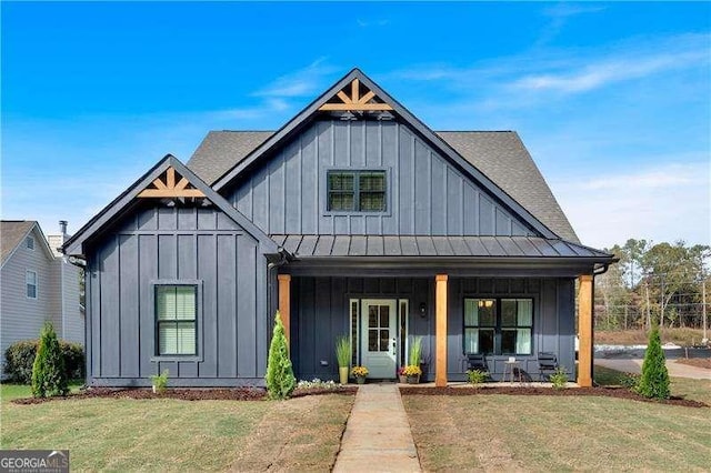 modern farmhouse style home featuring a front lawn and covered porch