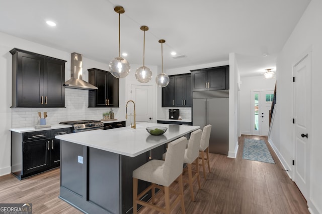 133 Old Alabama Rd SE, Emerson, GA 30137 - kitchen with wall chimney range hood, appliances with stainless steel finishes, a breakfast bar, decorative backsplash, and recessed lighting