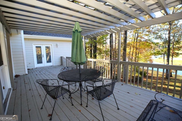 deck with french doors and a pergola