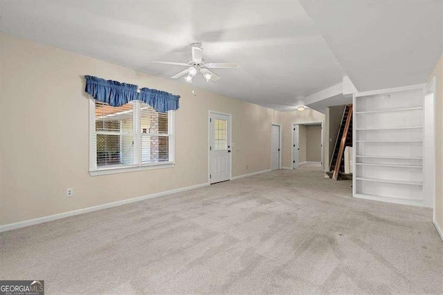 unfurnished living room with ceiling fan and light carpet