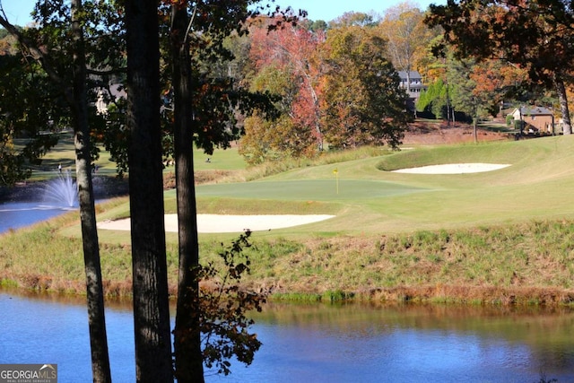 view of home's community with a yard and a water view