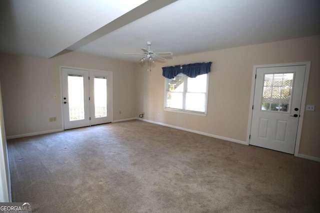 foyer featuring light colored carpet and ceiling fan