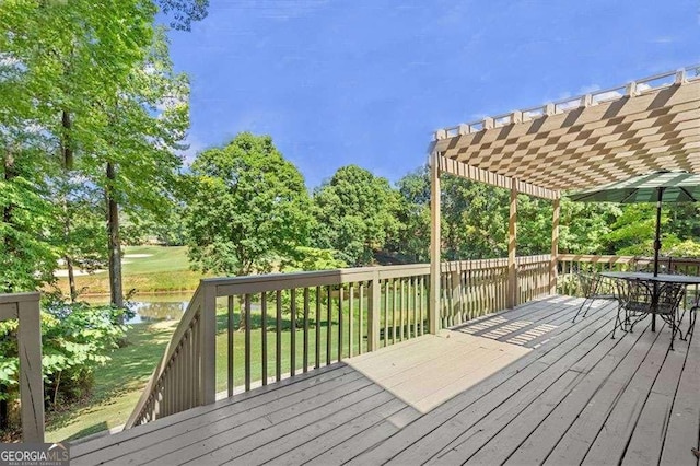 wooden deck featuring a water view, a yard, and a pergola