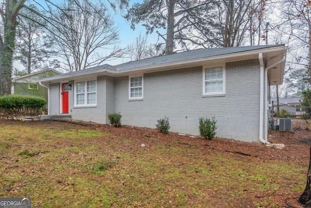 view of property exterior featuring cooling unit and a yard