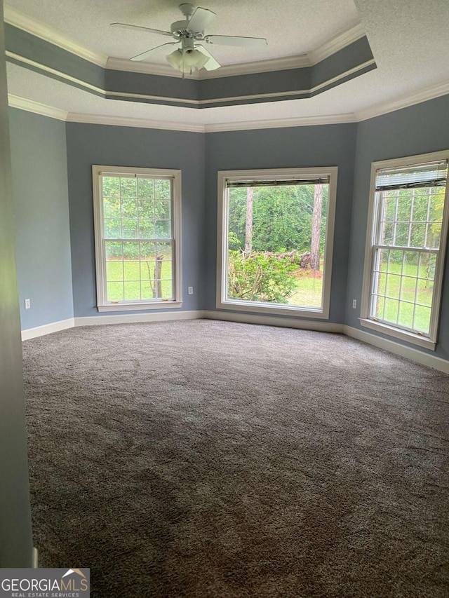 carpeted empty room featuring crown molding, ceiling fan, a tray ceiling, and a textured ceiling