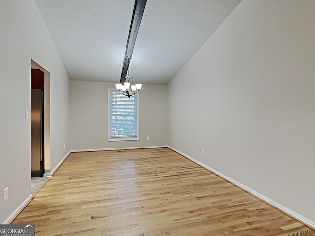 unfurnished dining area with a chandelier and light hardwood / wood-style flooring