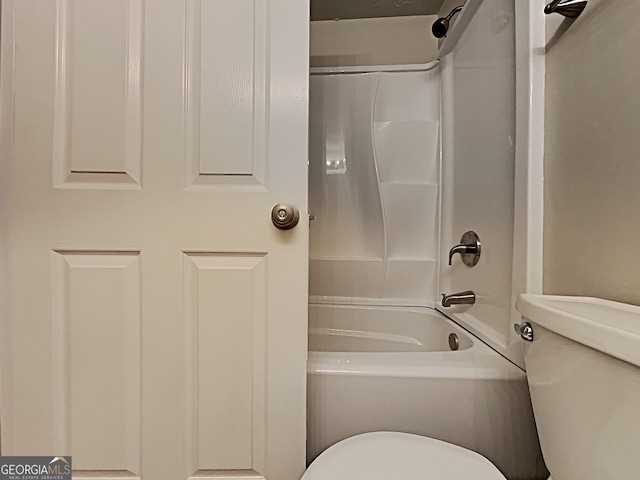 bathroom featuring shower / tub combination and toilet