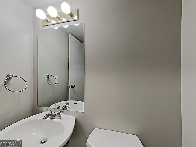 bathroom featuring sink and toilet