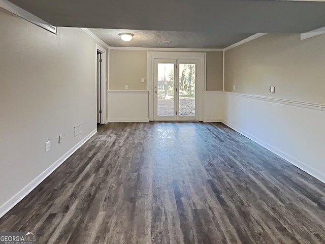 unfurnished room with crown molding and dark wood-type flooring