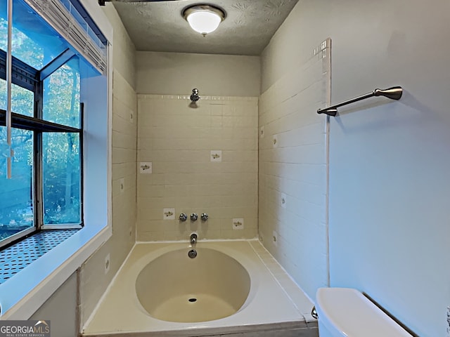 bathroom featuring toilet and a textured ceiling