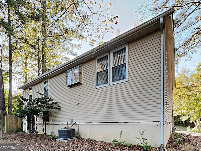 view of side of home with central air condition unit