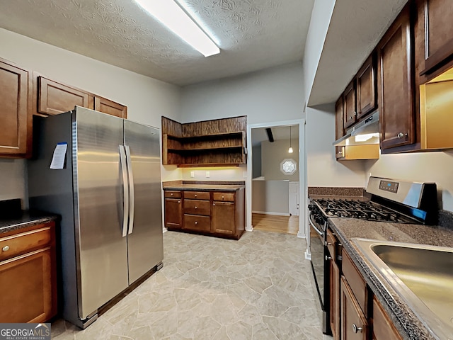 kitchen with stainless steel appliances and a textured ceiling