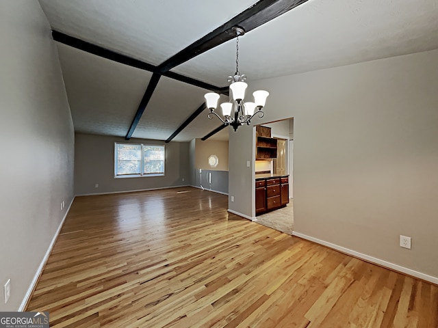 interior space featuring a notable chandelier, lofted ceiling with beams, and light hardwood / wood-style floors