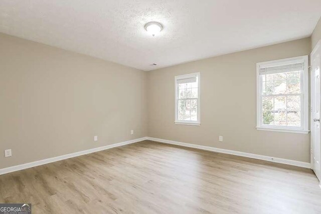145 Price Hills Ct, Sugar Hill, GA 30518 - spare room with wood finished floors and a textured ceiling