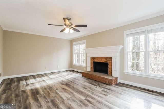 145 Price Hills Ct, Sugar Hill, GA 30518 - unfurnished living room featuring wood finished floors, a ceiling fan, a brick fireplace, and crown molding