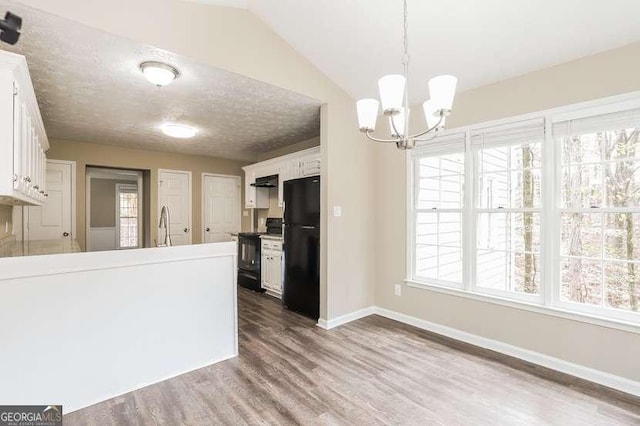 145 Price Hills Ct, Sugar Hill, GA 30518 - kitchen featuring black appliances, dark wood finished floors, white cabinetry, a chandelier, and pendant lighting