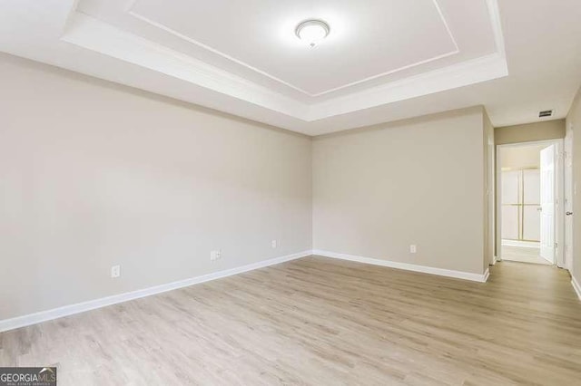 145 Price Hills Ct, Sugar Hill, GA 30518 - empty room with a tray ceiling and wood finished floors
