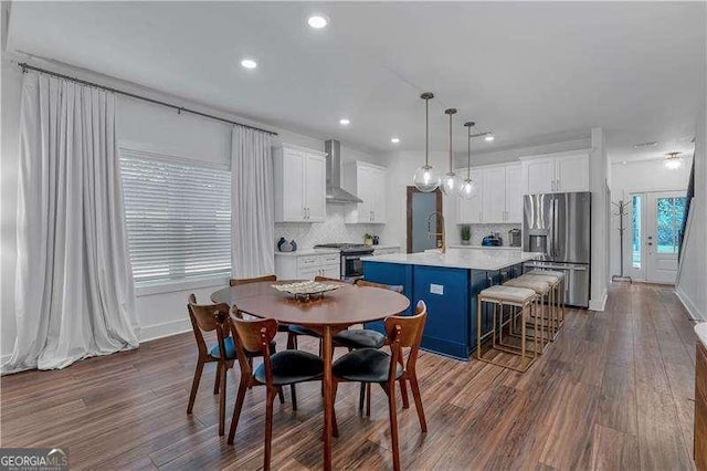 dining area with recessed lighting, dark wood finished floors, and baseboards