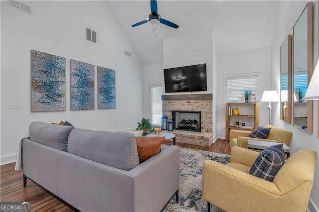 living room featuring high vaulted ceiling, a ceiling fan, wood finished floors, and visible vents
