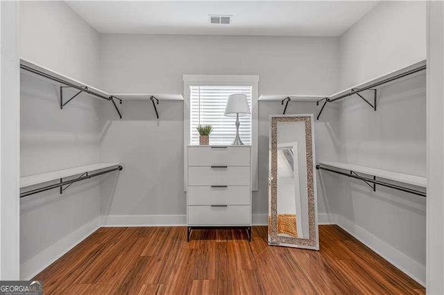 spacious closet with wood finished floors and visible vents