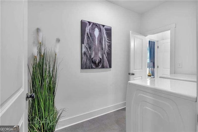 bathroom featuring baseboards and washer / clothes dryer