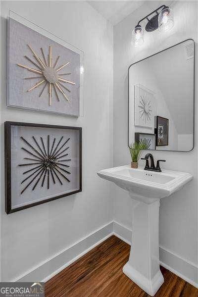 bathroom featuring wood finished floors and baseboards