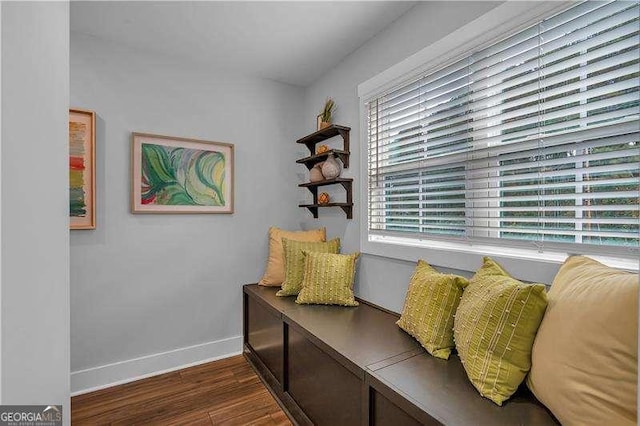 sitting room featuring dark wood finished floors and baseboards