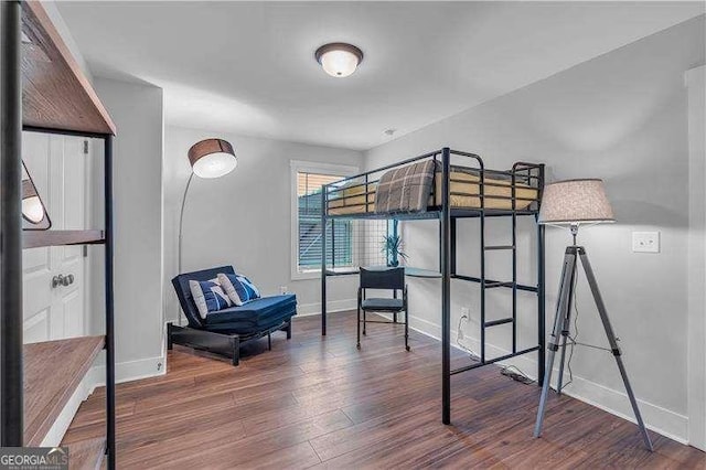 bedroom featuring baseboards and wood finished floors