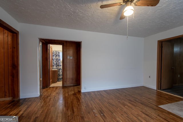 unfurnished room with dark hardwood / wood-style flooring, ceiling fan, and a textured ceiling