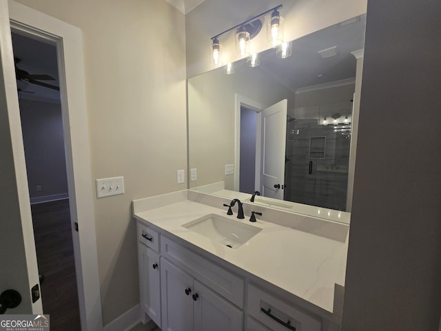 bathroom with crown molding, vanity, an enclosed shower, and wood-type flooring