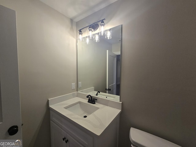 bathroom with vanity and toilet