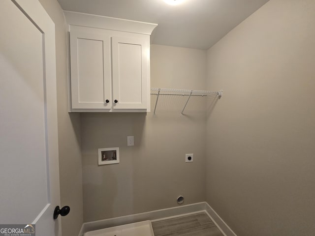 laundry room with cabinets, hookup for an electric dryer, hookup for a washing machine, and hardwood / wood-style floors