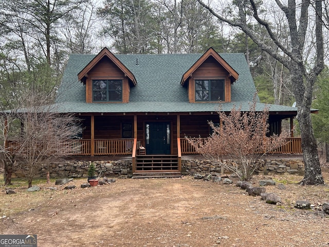 log cabin with a porch