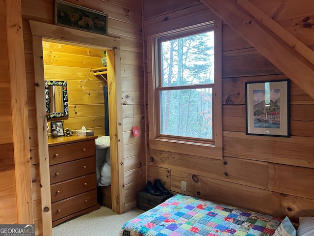 carpeted bedroom with wooden walls and a closet