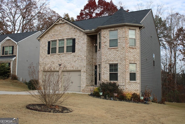 view of front of property with a garage and a front lawn