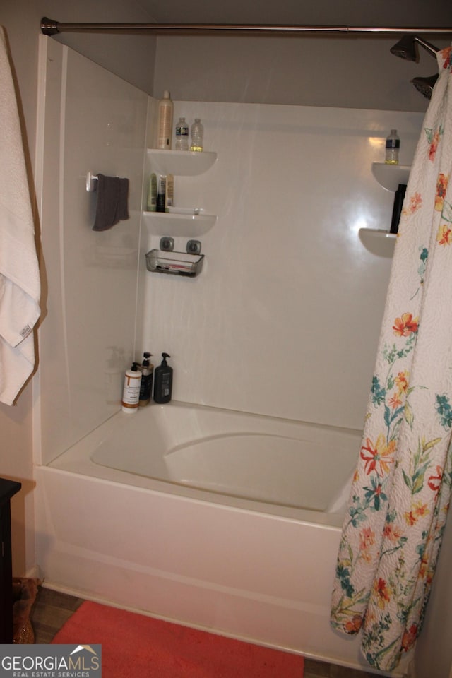 bathroom featuring hardwood / wood-style floors and shower / bath combination with curtain