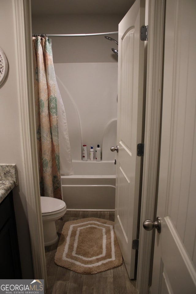 full bathroom with vanity, hardwood / wood-style floors, shower / bath combination with curtain, and toilet