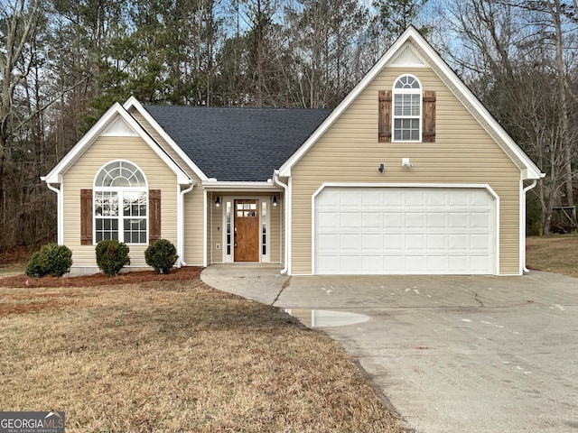 view of front of property featuring a garage and a front yard