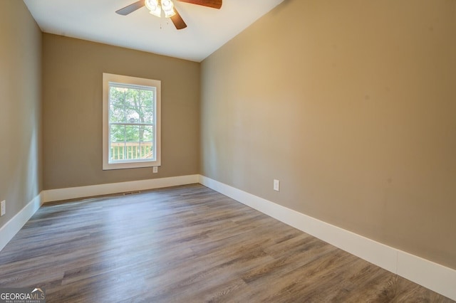 spare room with hardwood / wood-style flooring and ceiling fan