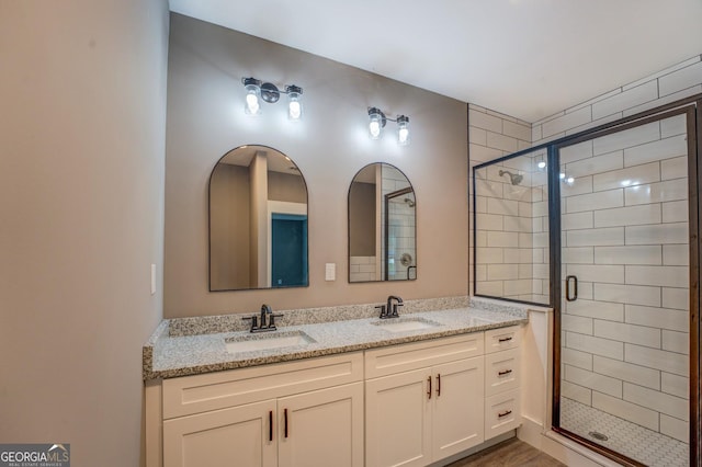 bathroom featuring vanity and a shower with shower door